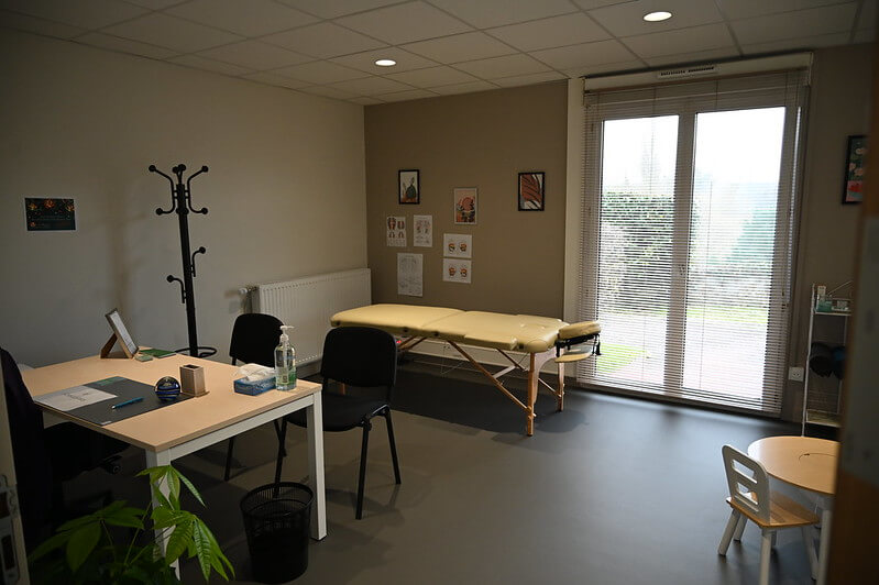 salle médical avec un bureau et une table de consultation