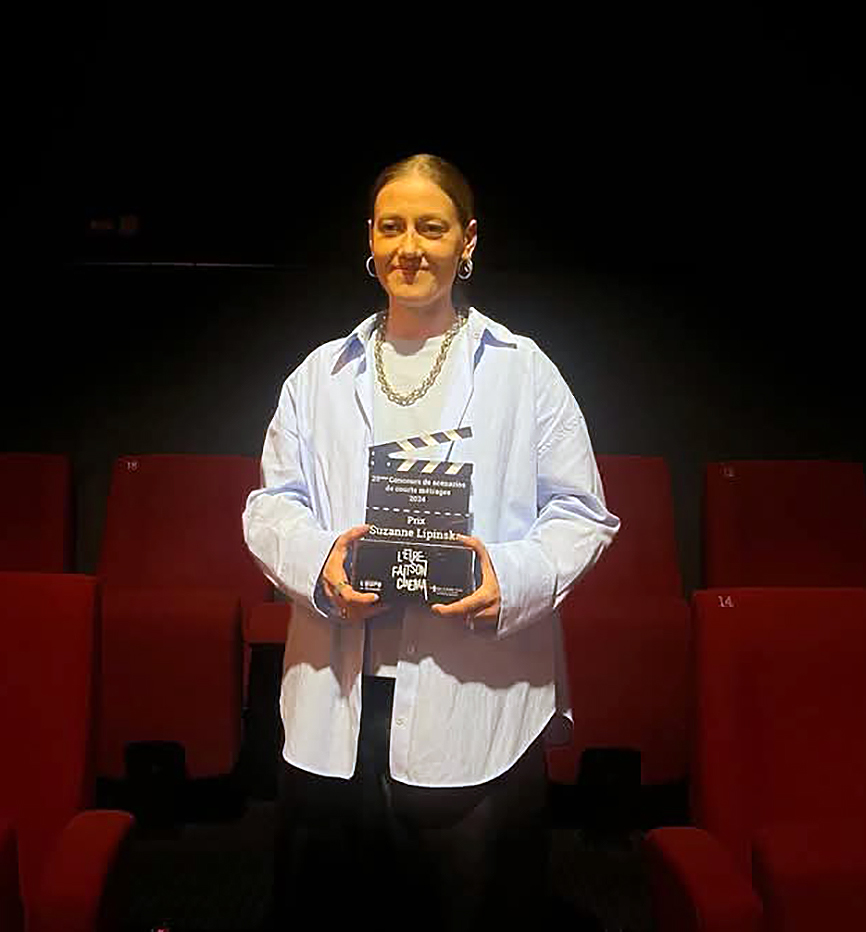 personne avec un trophée dans une salle de cinéma