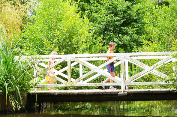 petite passerelle blanche au-dessous de l'eau avec deux personnes dessus