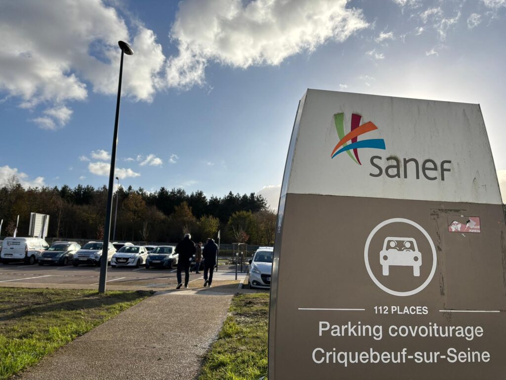 panneau en premier place avec parking et des voiture à l'arrière